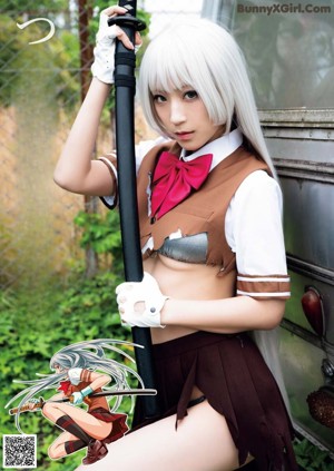 A woman in a school uniform holding a samurai sword.