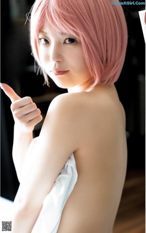 A woman in a maid outfit taking a selfie.