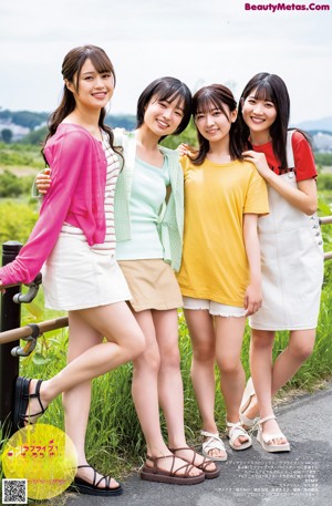 A group of young women in school uniforms posing for a picture.