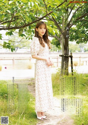 A woman in a plaid dress is posing for a magazine.