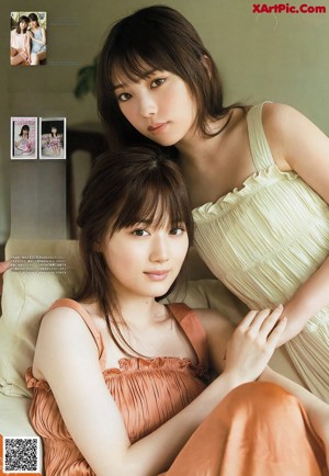 A couple of women sitting on top of a wooden floor.