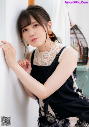 a japanese woman in a white shirt and a green hat