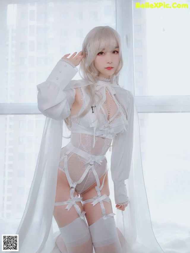 a woman in a white lingerie posing for a picture