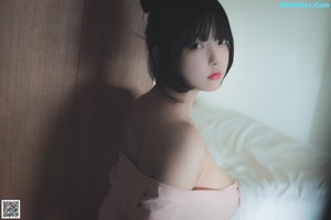 A woman laying on top of a bed in a white underwear.