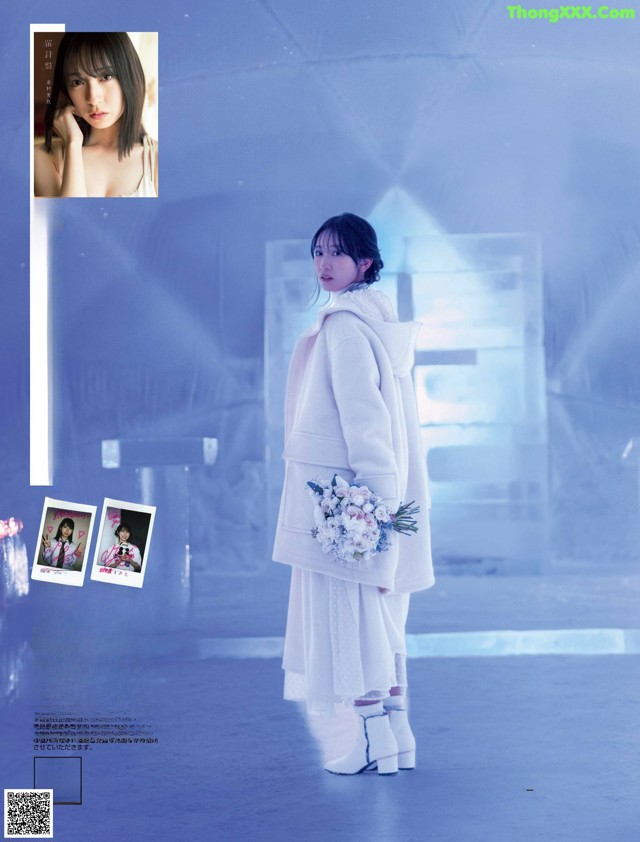 A woman in a white coat holding a bouquet of flowers.