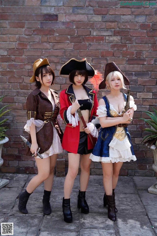 A group of three women dressed in pirate costumes posing for a picture.