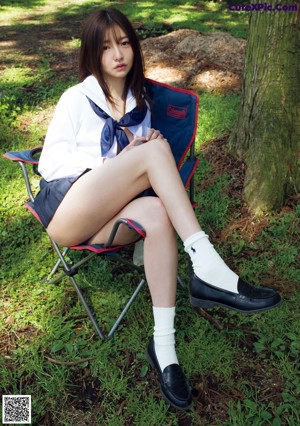 A woman in a white lingerie is sitting in the back of a van.