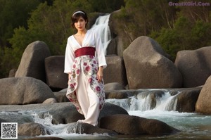 A naked asian woman in a yellow kimono leaning against a window.