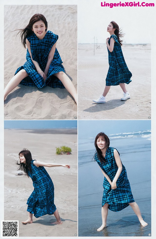 A woman in a blue and black plaid dress on the beach.