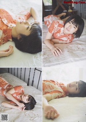 A woman laying on top of a bed next to a pillow.